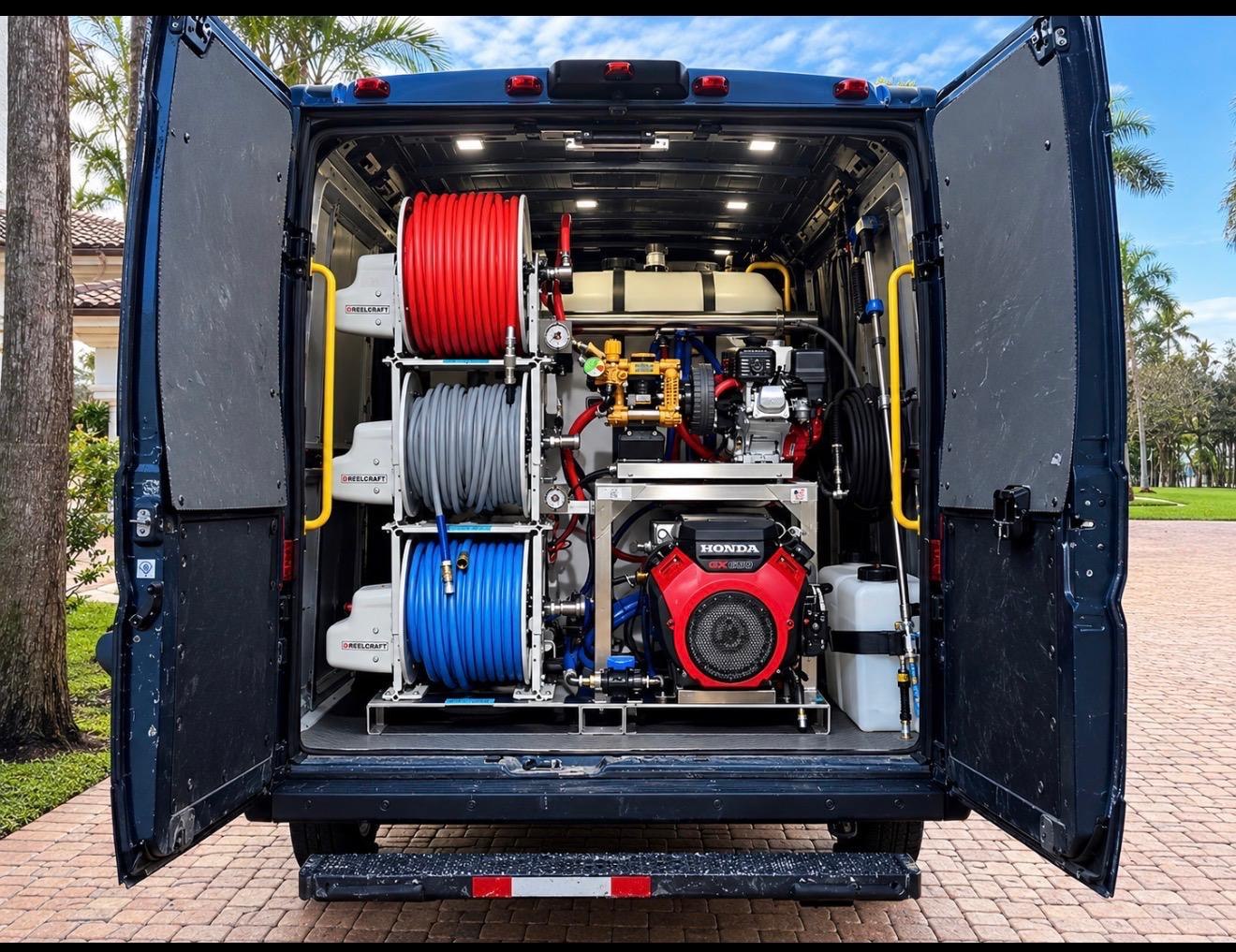 Open rear of the service van showing hose reels, tanks, and cleaning equipment