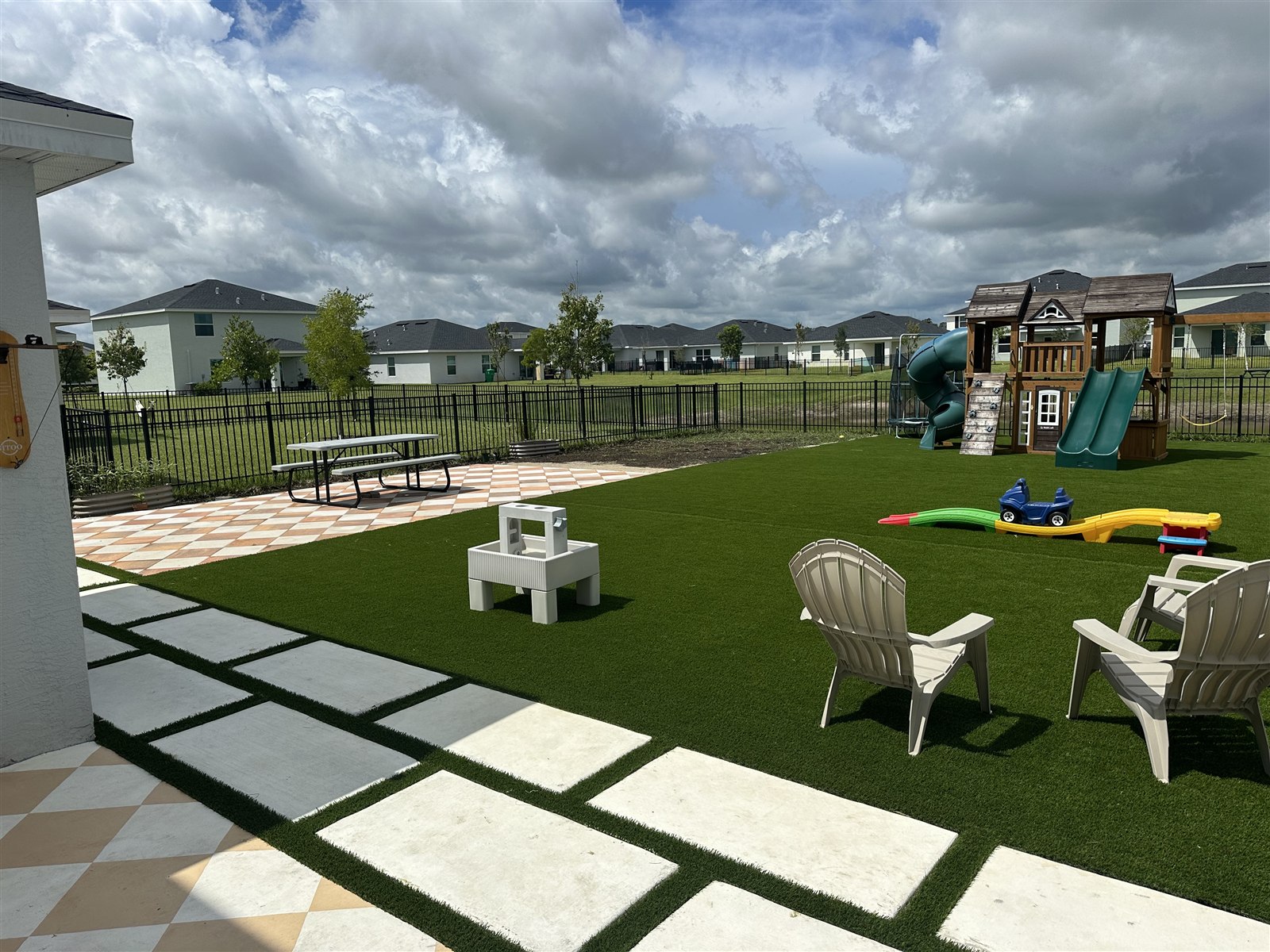 Turf installation, photo 4 of 4: finished artificial lawn around the backyard play area and patio